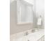 Bathroom featuring a marble countertop, chrome faucet, a mirror, and a built-in towel holder at 6685 Chapel Xing, Zionsville, IN 46077