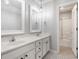 A stylish bathroom featuring double sinks, granite countertops, modern fixtures, and a shower room in view at 6685 Chapel Xing, Zionsville, IN 46077