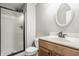 Bathroom with a glass-enclosed shower, decorative mirror, and vanity with a sink at 6685 Chapel Xing, Zionsville, IN 46077