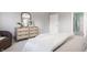 Relaxing bedroom with a dresser, plush bed, and doorway to another room at 6685 Chapel Xing, Zionsville, IN 46077