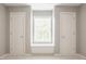 Neutral bedroom featuring carpet, a window with seating, and doors on each side of the window at 6685 Chapel Xing, Zionsville, IN 46077
