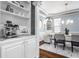 Dining room featuring built-in bar area with modern espresso machine, white cabinets, and hardwood floors at 6685 Chapel Xing, Zionsville, IN 46077