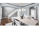 Bright dining room with light blue walls, modern lighting, and hardwood floors at 6685 Chapel Xing, Zionsville, IN 46077