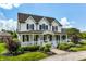 Charming two-story home boasts a welcoming front porch, manicured lawn, and lovely curb appeal at 6685 Chapel Xing, Zionsville, IN 46077