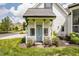 Charming white home features a covered front entrance with a blue door and lovely landscaping at 6685 Chapel Xing, Zionsville, IN 46077