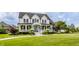 This elegant two-story home boasts a charming front porch and well-maintained landscaping, enhanced by a lush green lawn at 6685 Chapel Xing, Zionsville, IN 46077