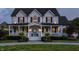 Beautiful two story home with a charming front porch, white siding and dark shutters, and a well manicured front yard at 6685 Chapel Xing, Zionsville, IN 46077