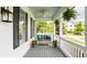Charming covered porch with a swing, ceiling fan, black shutters, and lush greenery at 6685 Chapel Xing, Zionsville, IN 46077