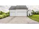 Attached two-car garage with a paved driveway provides convenient parking and storage space at 6685 Chapel Xing, Zionsville, IN 46077