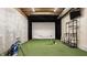 Basement golf simulator room with artificial turf, projector screen, and golf equipment at 6685 Chapel Xing, Zionsville, IN 46077