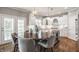 Beautiful kitchen with a large island, white cabinets, modern lighting, and stainless steel appliances at 6685 Chapel Xing, Zionsville, IN 46077