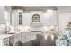 Bright kitchen featuring marble countertops, white cabinets, and modern fixtures at 6685 Chapel Xing, Zionsville, IN 46077