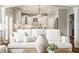 Cozy living room featuring a view into the well-lit modern kitchen with white cabinets at 6685 Chapel Xing, Zionsville, IN 46077