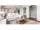 Open-concept living room with a view of the kitchen, showcasing elegant archways and neutral decor at 6685 Chapel Xing, Zionsville, IN 46077
