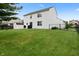 Expansive backyard featuring lush lawn, mature trees, and a fenced perimeter for added privacy at 6927 Rose Tree Ct, Indianapolis, IN 46237