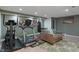 Finished basement featuring workout equipment and recreational space at 6927 Rose Tree Ct, Indianapolis, IN 46237