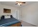 Neutral bedroom featuring a ceiling fan, carpet floors, and white walls at 6927 Rose Tree Ct, Indianapolis, IN 46237