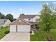 Charming two-story home with a brick and siding exterior, a well-manicured lawn, and a two-car garage at 6927 Rose Tree Ct, Indianapolis, IN 46237
