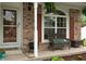 Cozy front porch with a wicker bench, perfect for relaxing and enjoying the outdoors at 6927 Rose Tree Ct, Indianapolis, IN 46237