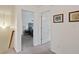 Upstairs hallway featuring access to bedrooms and neutral-toned carpeted floors at 6927 Rose Tree Ct, Indianapolis, IN 46237
