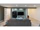 Finished basement featuring a comfortable living room with a large TV and a secure gun safe at 6927 Rose Tree Ct, Indianapolis, IN 46237