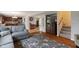 Open-concept living room showcasing seamless flow to the kitchen and staircase, with hardwood floors at 6927 Rose Tree Ct, Indianapolis, IN 46237