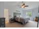 Comfortable main bedroom with a ceiling fan and a view of the yard from the window at 6927 Rose Tree Ct, Indianapolis, IN 46237