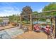 Expansive wooden back deck featuring a pergola, seating, and a view of the pool and backyard at 7025 Chimney Rock Ct, Indianapolis, IN 46217