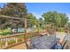 Wooden back deck with a dining table, bench seating, and a view of the pool and spacious backyard at 7025 Chimney Rock Ct, Indianapolis, IN 46217