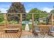 Inviting back deck overlooking a beautiful backyard with a pool, mature trees, and lush lawn at 7025 Chimney Rock Ct, Indianapolis, IN 46217
