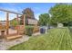 Spacious backyard with a wooden deck, in-ground pool, shed, lush green lawn, and fenced perimeter at 7025 Chimney Rock Ct, Indianapolis, IN 46217