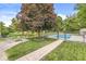 Landscaped backyard featuring a fire pit area, mature trees, and a fenced swimming pool at 7025 Chimney Rock Ct, Indianapolis, IN 46217