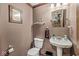 Powder room featuring pedestal sink, toilet and neutral walls at 7025 Chimney Rock Ct, Indianapolis, IN 46217