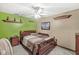 Cozy bedroom featuring a ceiling fan, neutral walls, and a comfortable bed with a patterned quilt at 7025 Chimney Rock Ct, Indianapolis, IN 46217