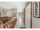 Tiled hallway view with wooden accents and charming Gathering photos adorn the walls at 7025 Chimney Rock Ct, Indianapolis, IN 46217