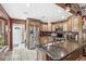 Well-lit kitchen featuring granite countertops, stainless steel appliances, and wood cabinets at 7025 Chimney Rock Ct, Indianapolis, IN 46217