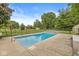 In-ground swimming pool with a concrete surround, fenced for safety, in a spacious backyard at 7025 Chimney Rock Ct, Indianapolis, IN 46217