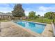 Fenced in-ground swimming pool nestled in a spacious backyard with lush greenery and mature trees at 7025 Chimney Rock Ct, Indianapolis, IN 46217