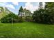 Large backyard with vibrant green grass and mature trees at 713 W Cromer Ave, Muncie, IN 47303