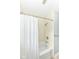 Bright bathroom features a shower with white tiled walls and neutral flooring at 713 W Cromer Ave, Muncie, IN 47303