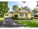 Charming yellow home with well-manicured lawn and detached garage and drive at 713 W Cromer Ave, Muncie, IN 47303
