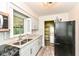 Bright kitchen featuring a modern countertop, stainless steel microwave, and adjacent laundry area at 713 W Cromer Ave, Muncie, IN 47303