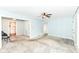 A living room with natural light, gray carpet, and a ceiling fan at 713 W Cromer Ave, Muncie, IN 47303