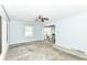 Bright living room with natural light, gray carpet, and a ceiling fan at 713 W Cromer Ave, Muncie, IN 47303