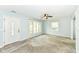 Bright living room with large windows, neutral carpet, and ceiling fan at 713 W Cromer Ave, Muncie, IN 47303