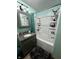 Updated bathroom with granite counters, decorative mirror, and shower with built-in shelving at 719 Henry St, Lebanon, IN 46052