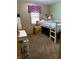 Cozy bedroom with carpet, a large window, and a bed and desk at 719 Henry St, Lebanon, IN 46052