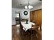Charming dining room featuring hardwood floors, a classic chandelier, and a view into the living room at 719 Henry St, Lebanon, IN 46052