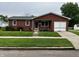 Charming brick home featuring a well-maintained front yard and an attached garage at 719 Henry St, Lebanon, IN 46052