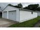 Detached two-car garage with white siding and a concrete driveway at 719 Henry St, Lebanon, IN 46052